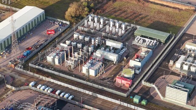 Close up aerial drone view of high voltage insulators and electrical busbars at Walpole substation UK during a critical infrastructure grid upgrade.