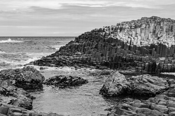 A rocky shoreline with a body of water in the background