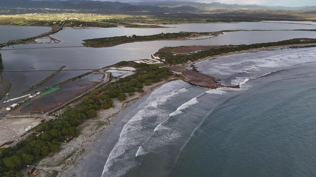 Aerial Drone View of Waves Crashing on a Curved Breakwater in Porto Pino, Sardinia, Italy