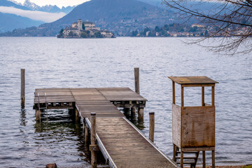 Winter view of Orta San Giulio island, in the Orta Lake (piedmont, Northern Italy) seen from a lake pier. UNESCO World Heritage Site, it is home to a convent of cloistered nuns. © stefanopez