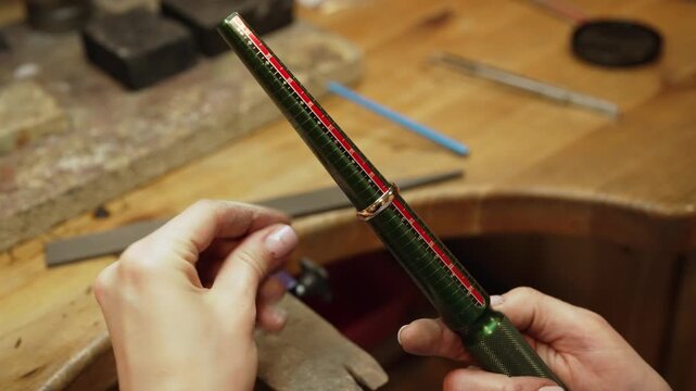 Jeweler checking ring size with measuring mandrel.