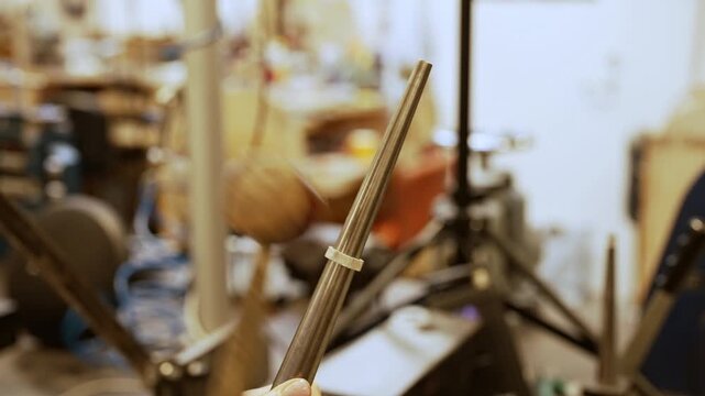 Jeweler shaping silver ring with rawhide mallet.