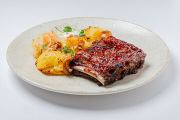 Juicy ribs glazed with a rich sauce alongside golden roasted potatoes and vibrant vegetables