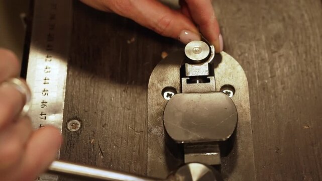 Jewelers hand using professional ring bender.