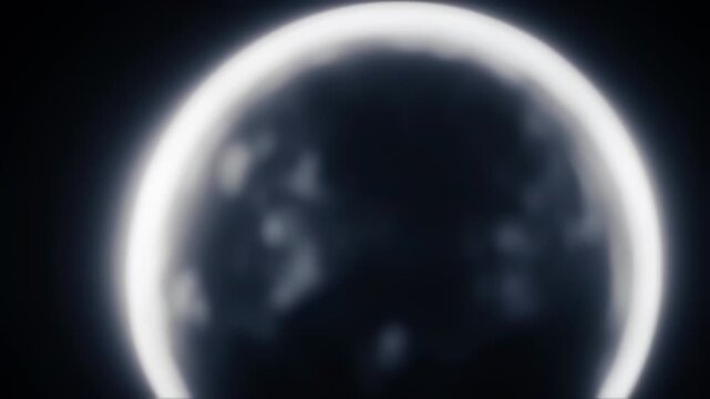 Glowing orb with a blurred surface against a black background. Suggests a celestial body in space
