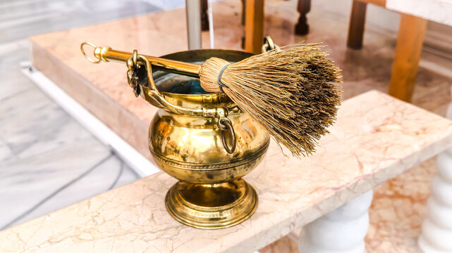 Golden Holy Water Sprinkler and Bucket on Marble Altar in Church