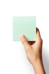 Obraz premium Green pastel Sticky note hand holding paper.