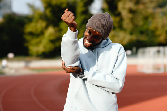 Man experiencing elbow pain during outdoor workout