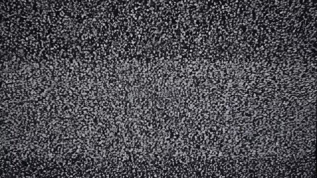 A dense, abstract textured pattern of small, irregularly shaped pebbles in grayscale