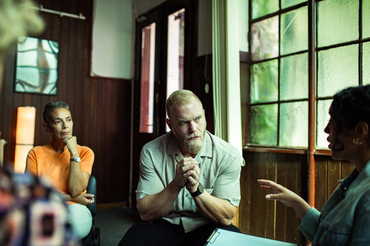 Adults in therapy support group discussion at community center