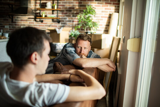 Two men having a serious talk at home