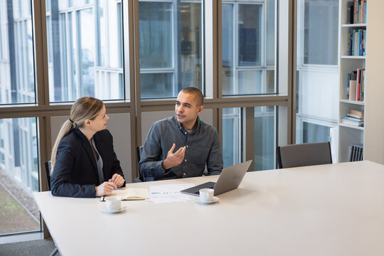 Business Meeting with Two Professionals in Office