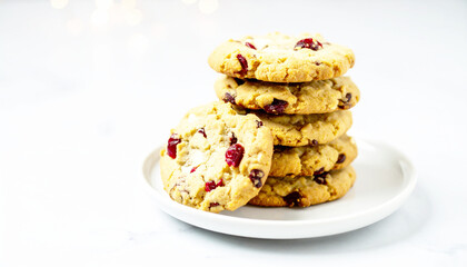 Homemade white chocolate chip and cranberry cookies, white plate. AI