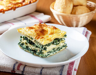 Lasagna Florentine with spinach and ricotta on a plate, closeup. AI