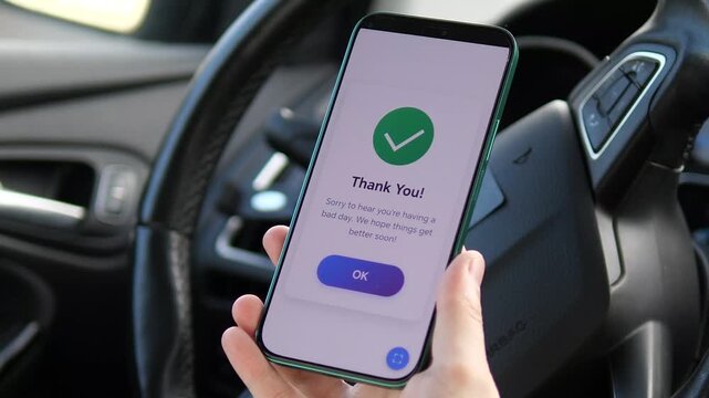 User tracking emotional well-being on a mood tracker app inside a car. Selecting Bad Mood on a sleek interface for mental health monitoring. Ideal for healthcare tech, wellness, and self-care digital