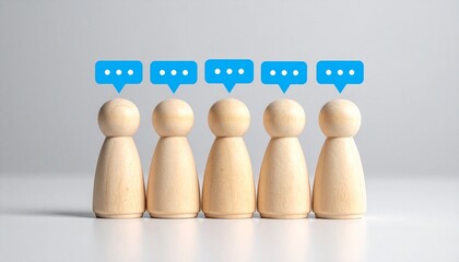 Row of Miniature Wooden Figures with Blue Chat Speech Bubbles for Team Communication, Social Networking, and Public Opinion Concept