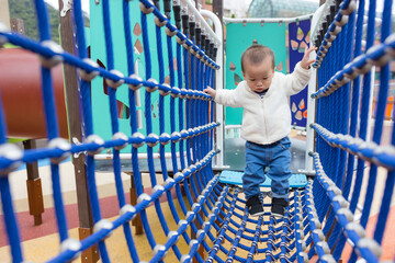 Baby climbing rope net at outdoor kid park