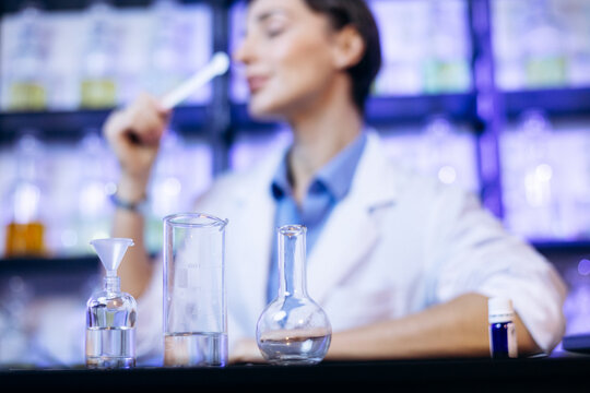 Female perfumer crating perfumes at her laboratory