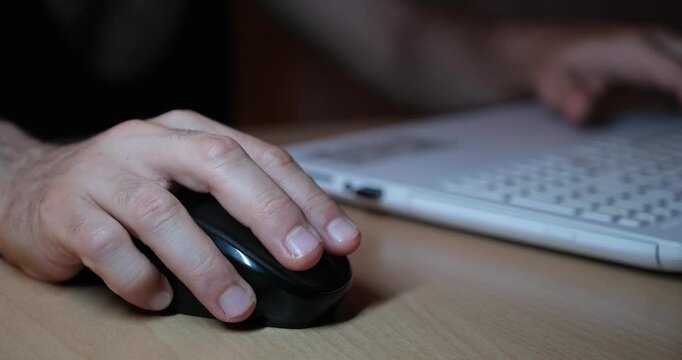 Hand Using Mouse While Working on Laptop, Close-Up of Computer Workspace