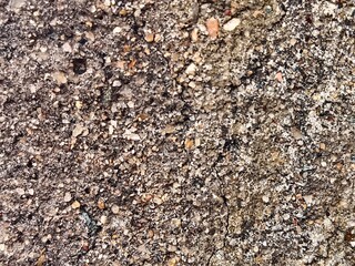 Macro Texture of Weathered Asphalt and Concrete - Detailed Background of Gritty Pebble Surface with Cracked Industrial Pavement
