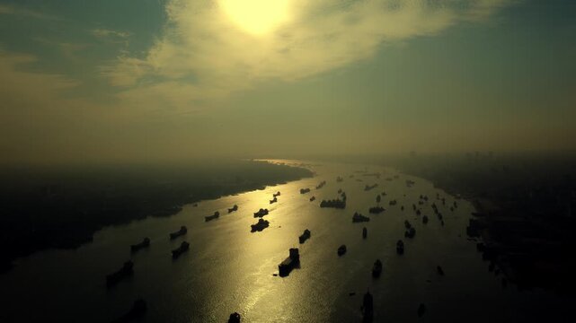 Aerial View of Cargo Ships on a River at Golden Hour Silhouette in Karnaphuli 4k