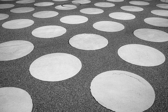 Abstract circles pattern on concrete pavement with urban texture and geometry creating clean surface design for modern backgrounds and branding