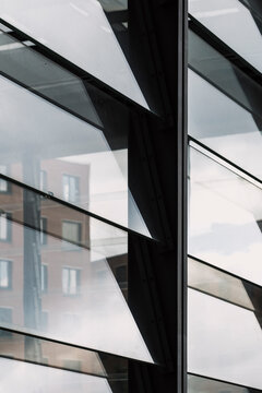 Modern glass facade with reflection and clean lines showing urban architecture windows and abstract structure for corporate background design