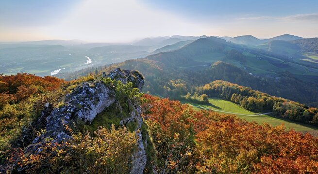 View of an autumnal forest from the Gisliflue, behind the Jura foothills with Wasserfluh and Strihen, Talheim, Canton, Aargau, Switzerland