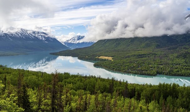 View of snowy mountains in spring and turquoise blue Kenai Lake, Slaughter Ridge Trail, Cooper Landing, Kenai Peninsula, Alaska, USA