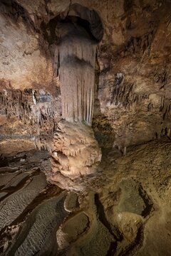Stalactites and stalagmites, rock formations in a stalactite cave with water basin, Grotta del Fico, Gulf of Orosei, Baunei, Sardinia, Italy