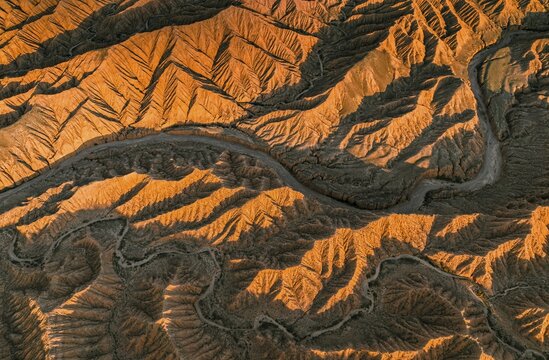 Aerial view, View from above, Canyon runs through landscape, Dramatic barren landscape of eroded hills, Badlands, Canyon of the Forgotten Rivers, Issyk Kul, Kyrgyzstan
