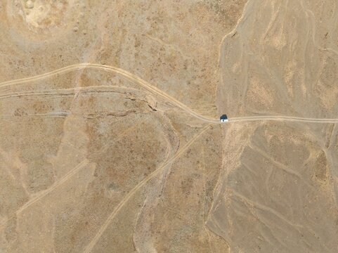 Aerial view, Vast empty landscape, Road and off-road vehicle, Top down view, Two paths divide, Symbolic for decisions, Moldo Too mountains, Naryn region, Kyrgyzstan
