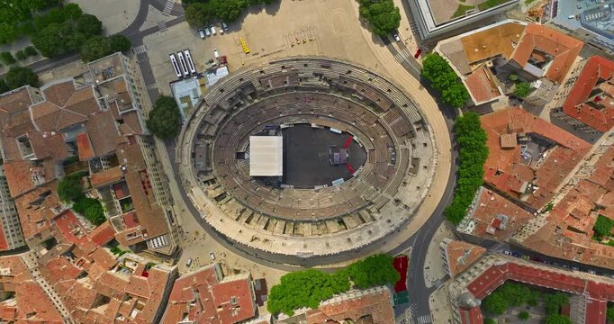 Aerial view of famous Arena of Nimes, France. Old Roman amphitheatre at sunset