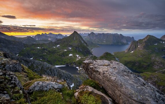 View over mountain tops and sea, with lakes Litlforsvatnet and Tennesvatnet and fjord Forsfjorden, dramatic sunset, from Hermannsdalstinden, Moskenes&ouml;y, Lofoten, Nordland, Norway