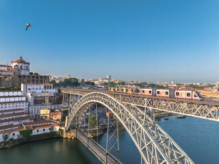 Fototapeta premium Dom Luis Bridge in Porto City, Portogal. Drone. Douro River. Monastery in Background