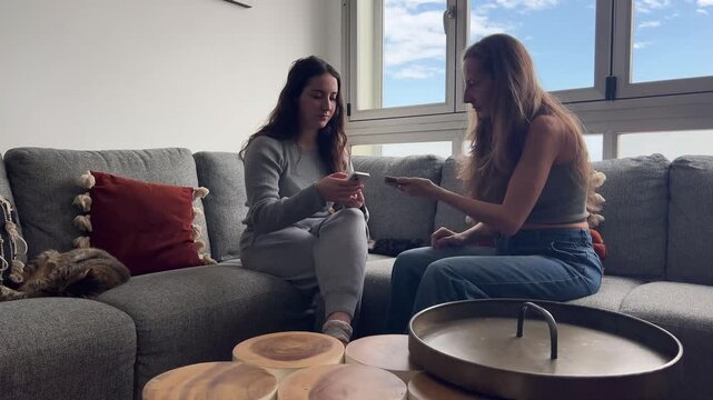 Influencer y amiga revisando contenido y comparti&eacute;ndolo digitalmente