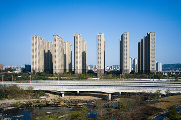 Obraz premium High-rise residential buildings and overpass over river in city