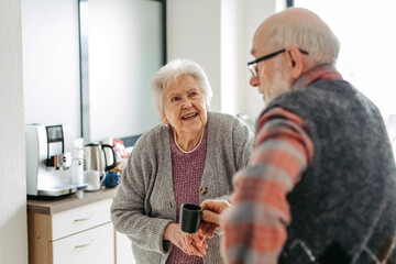 Fototapeta na wymiar Elderly couple having lunch in community center cafeteria.