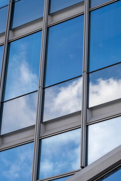 Abstract facade of modern glass skyscraper reflection featuring corporate office architecture in urban Paris with simple symmetry and neutral tones