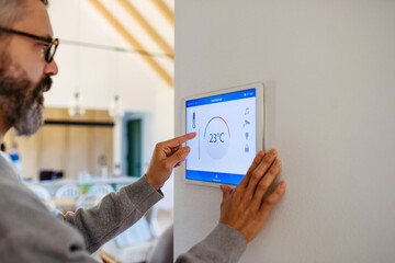 Man using smart home control panel.