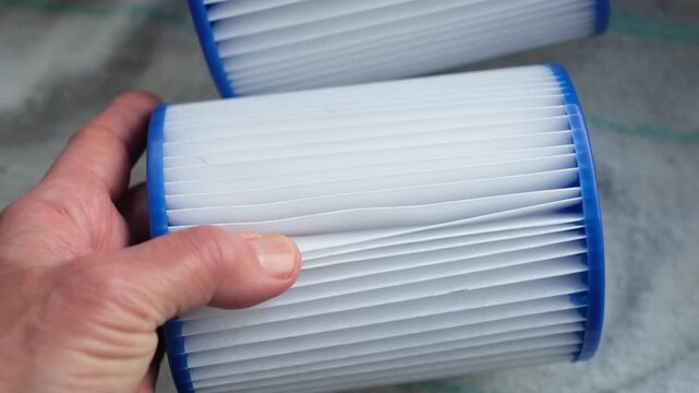 Pleated polyester material of the pool cartridge. Demonstration of a reusable pool cartridge in hand. Strength and designed for durability, washability, and reuse.