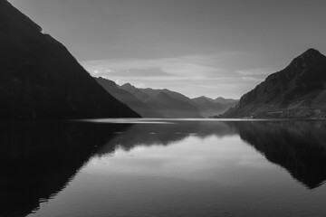 Black and white wide panorama of mountain lake at Lago Idro Italy