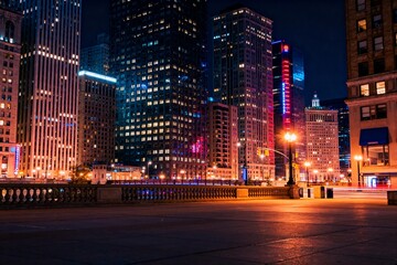 Obraz premium Nighttime Urban Skyscrapers with Illuminated Windows
