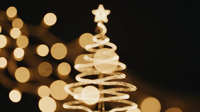 Slow motion close-up of shimmering golden bokeh lights drifting past a subtle futuristic Christmas pine tree shape formed by warm soft light trails bokeh, elegant, subtle