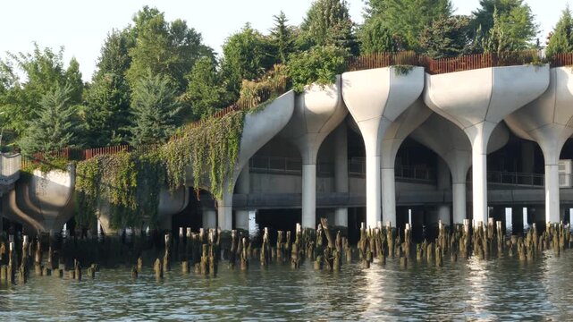 New York City Little Island pier park, oasis in Manhattan Midtown, United States. Urban architecture on pillars in Chelsea, USA. Futuristic contemporary concrete columns design, Hudson river landmark.