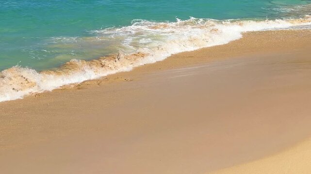 Golden sandy beach, the bright blue and turquoise waters of the Caribbean Sea and the green slopes of a low mountain on the island of St. Maarten. Saint Martin is an island in the Caribbean.