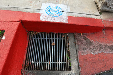 No Dumping &ndash; This Drains to Ocean. Drain Environmental Sign on the sidewalk