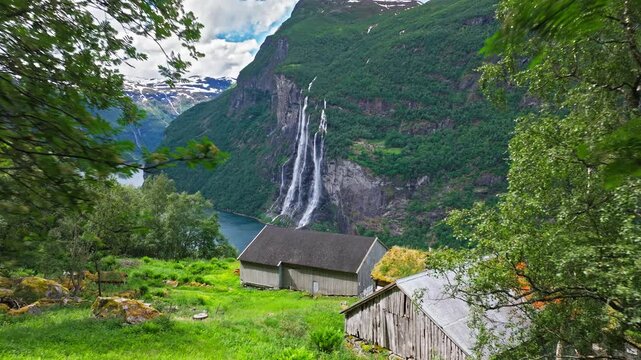 Skagefl&aring; Mountain Farm Over Geirangerfjord. The historic Skagefl&aring; farm clings to a steep mountainside above Geirangerfjord in western Norway during summer, creating a dramatic and timeless Nordic mood