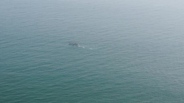 29.12.2025. Puri Orissa India aerial video clip of a lonely boat sailing through the  deep bluish sea water in India
