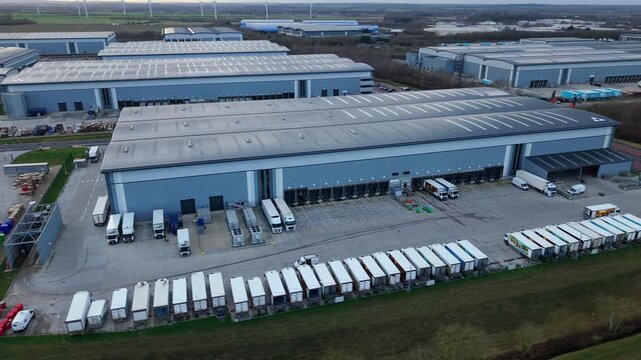 Biggleswade, United Kingdom - 24 January 2026: Aerial view of rows of trucks and warehouses under a cloudy sky, showing the scale of logistical operations.